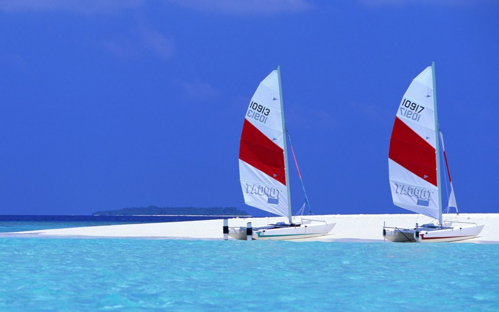 Dual Sail Boats On Blue Beach Fhd Wallpaper